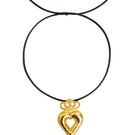 Gold crowned heart necklace by Natia x Lako featuring a delicate chain and a heart pendant with a crown design.