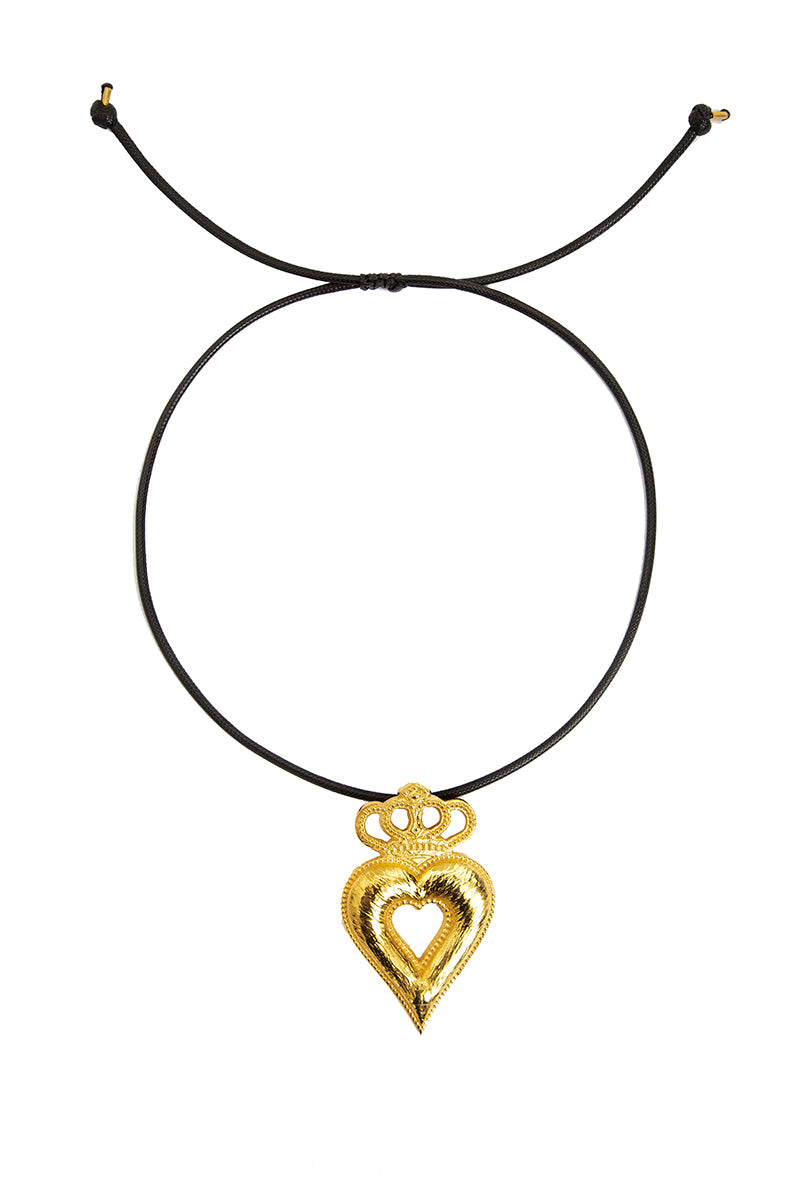 Gold crowned heart necklace by Natia x Lako featuring a delicate chain and a detailed heart pendant with a crown design.