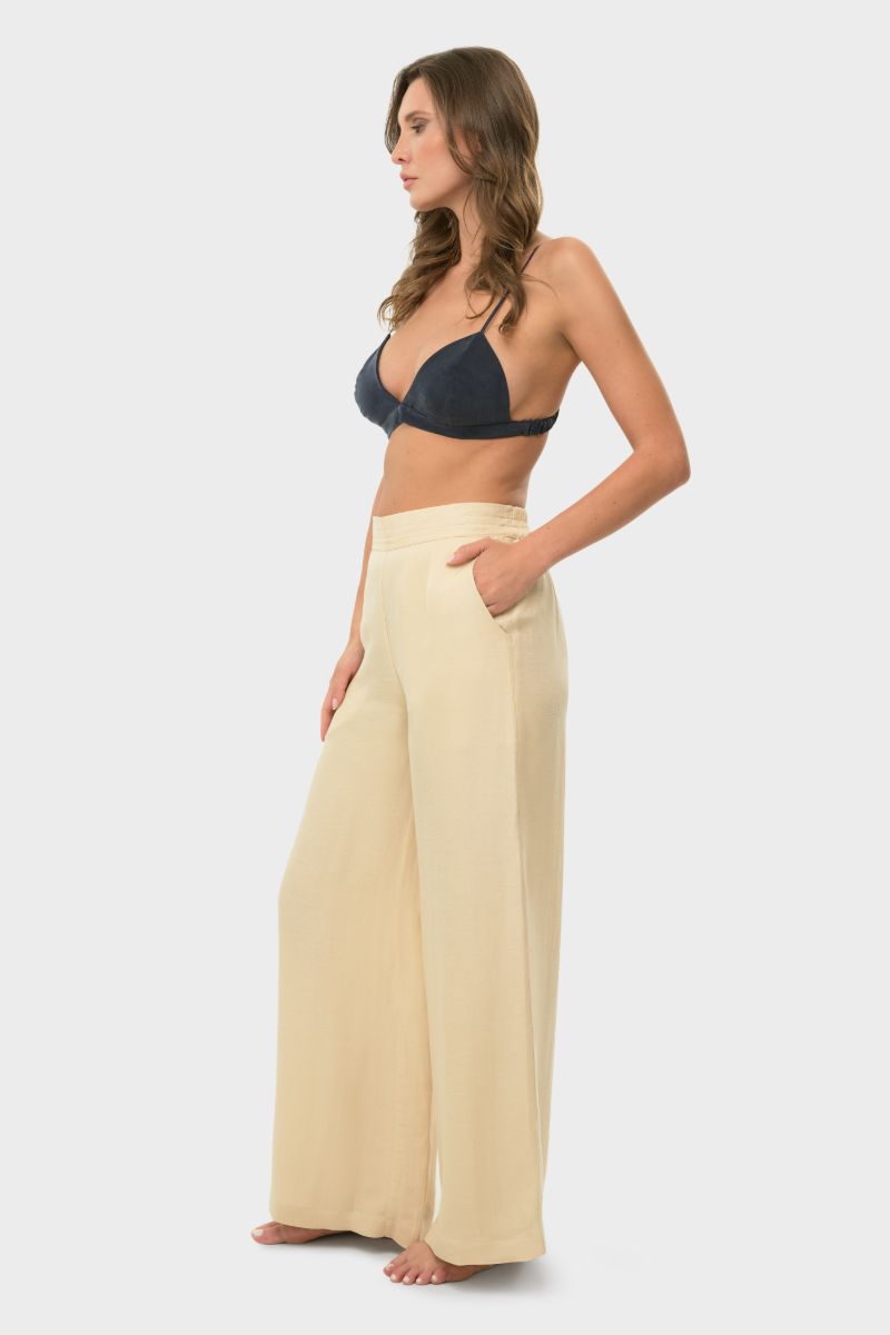 NiLuu creme lounge pants laid flat, showcasing soft fabric and relaxed fit for comfortable casual wear.