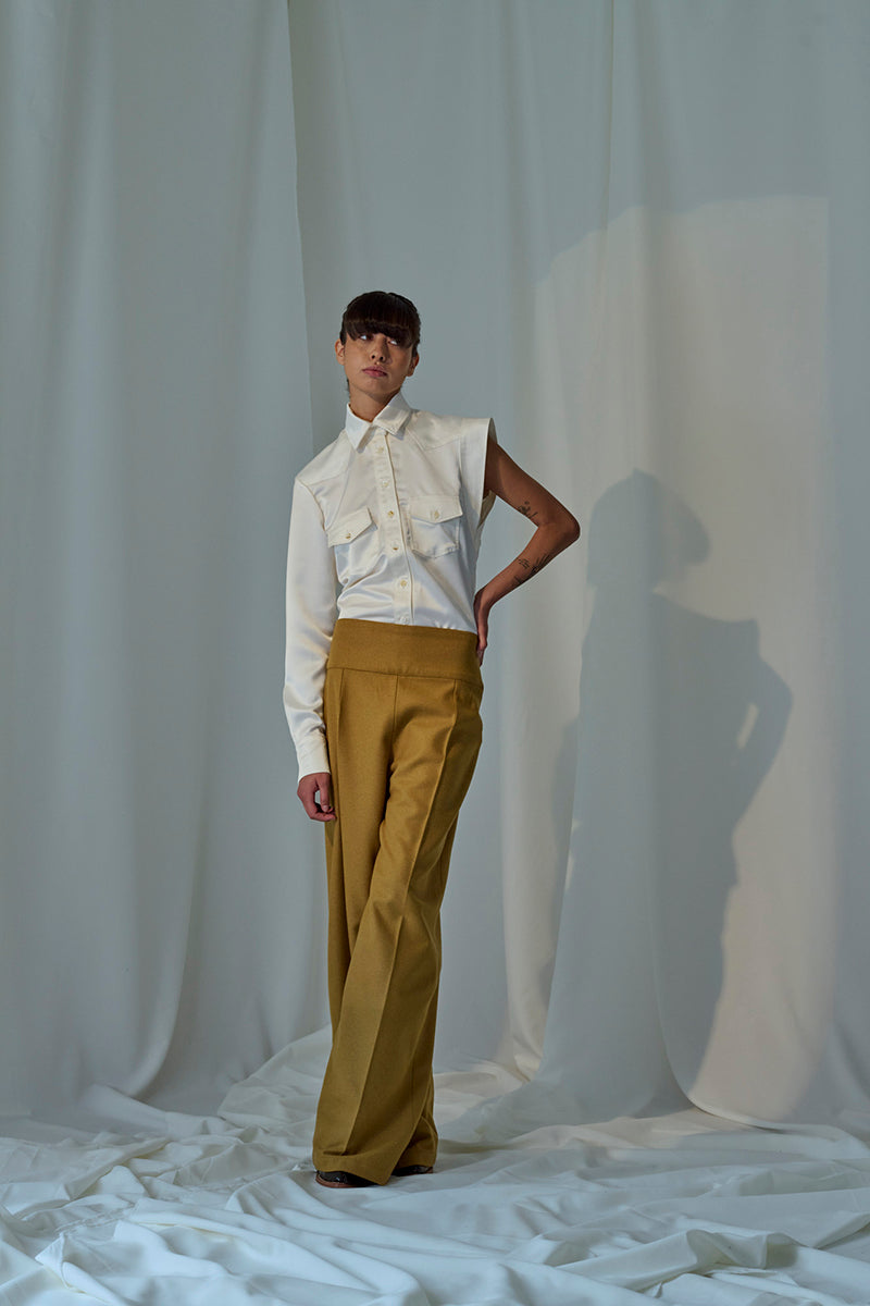 Lorena Saravia Isabela blouse, stylish shirt with flowy fabric and detailed design, displayed on a hanger.