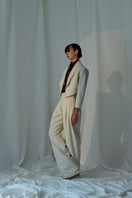 Lorena Saravia Alex wool pants in neutral fabric, tailored fit, featuring waistband and front pockets.