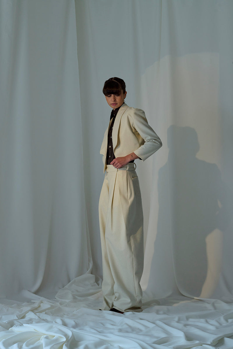 Lorena Saravia Alex wool pants in neutral fabric, tailored fit, front pockets, and wide-leg design, perfect for stylish office wear.