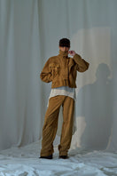 Lorena Saravia Julia suede pants in neutral color, showcasing their tailored fit and soft suede texture.
