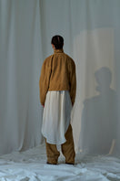 Lorena Saravia Julia suede pants in neutral color, close-up showing soft suede fabric and tailored fit.