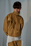 Lorena Saravia Julia suede jacket in soft beige with a tailored fit and classic collar, displayed on a hanger.