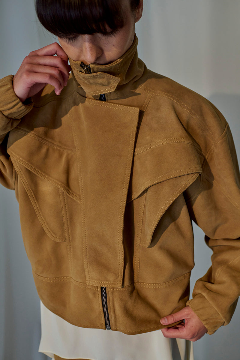 Lorena Saravia Julia suede jacket in a stylish design, displayed on a hanger against a neutral background.