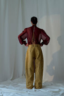 Lorena Saravia Alex brown pants featuring a relaxed fit, waistband, and stylish tailoring, shown on a model.