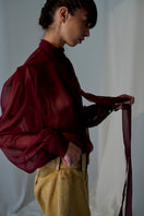 Lorena Saravia Natalia blouse in soft fabric with elegant neckline, styled as a trendy women's top.