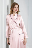 Pink silk long robe for women by MANITO, featuring smooth fabric and elegant design, displayed on a mannequin.