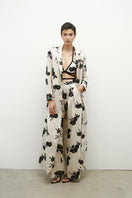 Long linen coat with sequins by JC Pajares, featuring a stylish design and shimmering details, perfect for elegant occasions.
