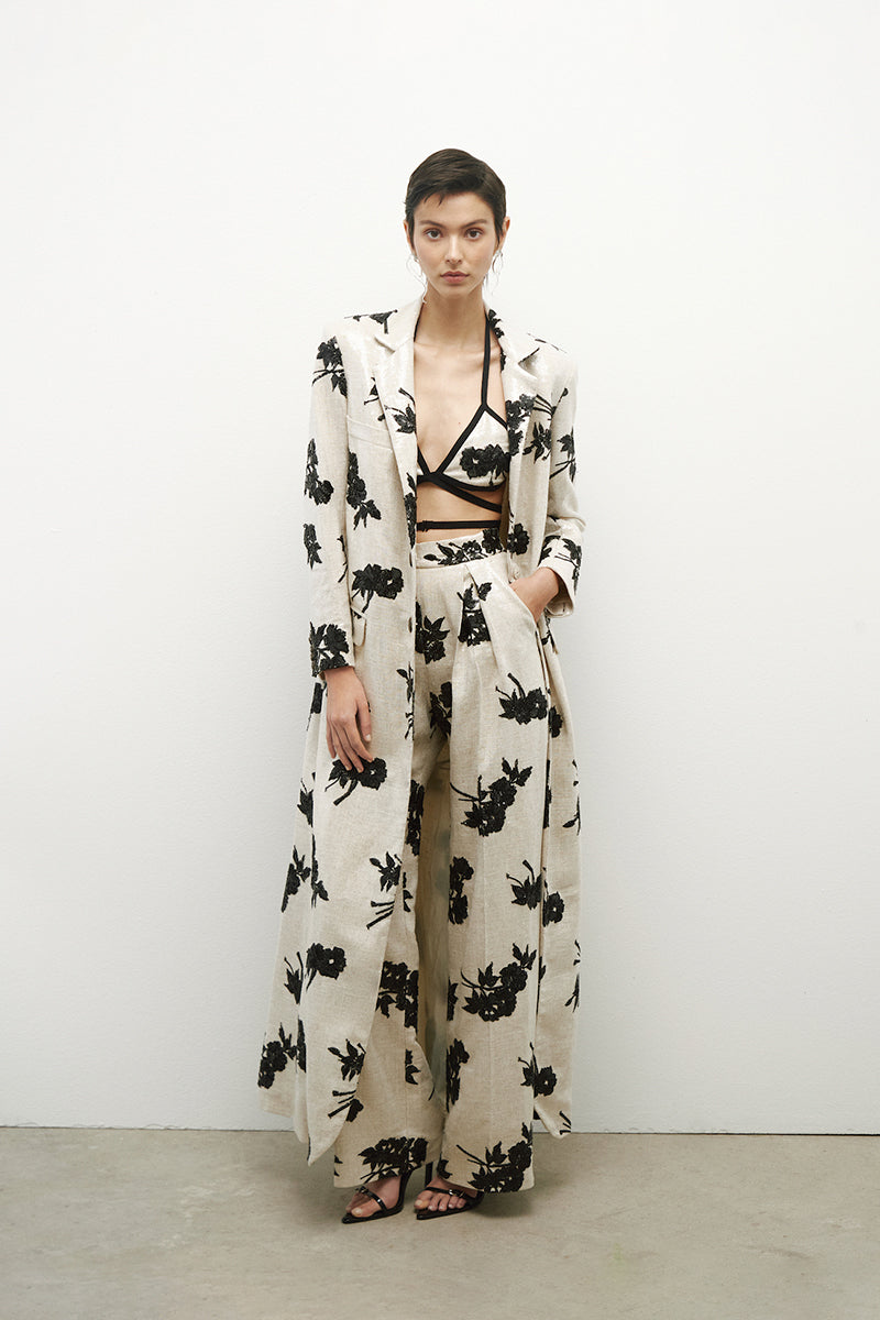 Long linen coat with sequins by JC Pajares, featuring a stylish design and shimmering details, perfect for elegant occasions.