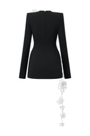 L'SCARLETT long-sleeve black poly crepe mini dress worn by a model, featuring a fitted silhouette and stylish design.