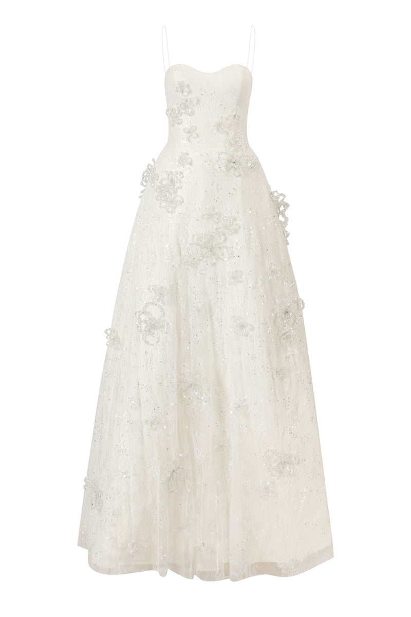 White L'Scarlett A-line maxi dress with spaghetti straps, glitter lace details, and a flowing silhouette in this stylish image.