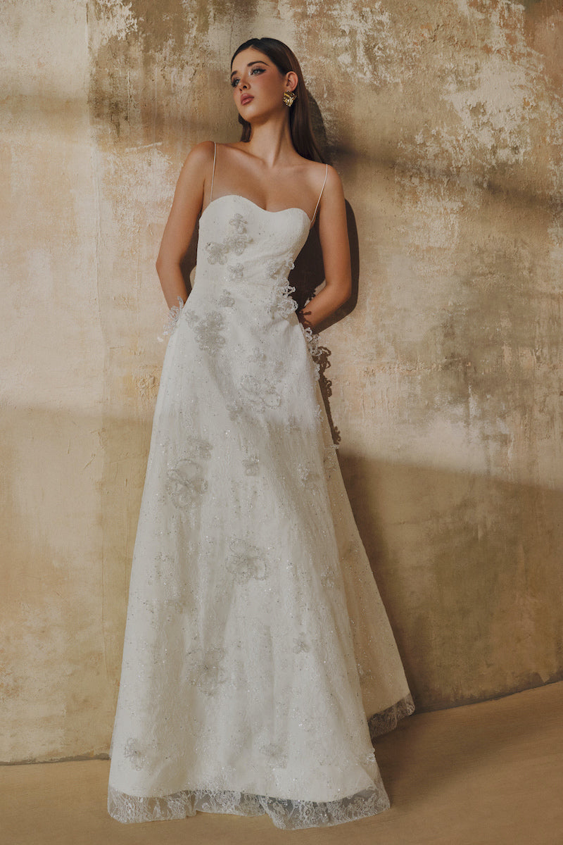 White L'SCARLETT A-line spaghetti straps glitter lace maxi dress, elegant and flowing with intricate lace details.