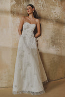 White L'SCARLETT A-line spaghetti straps glitter lace gown with elegant design and intricate lace details.