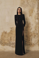 Black long-sleeve gown with heart beading detail and front slit by L'SCARLETT, shown from the front view.