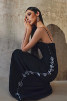 L'SCARLETT gown with shoulder straps, elegant long dress featuring a flowing fabric and stylish design for formal occasions.