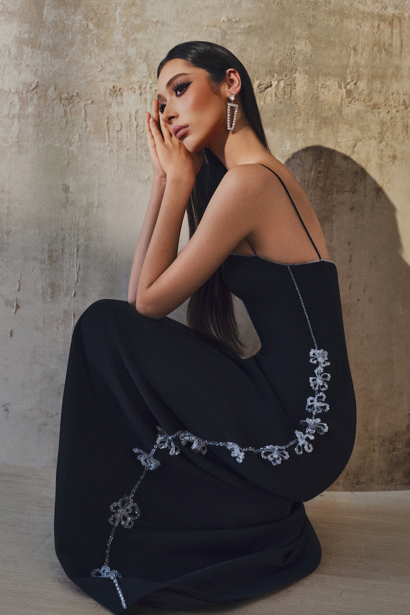 L'SCARLETT gown with shoulder straps, elegant long dress featuring a flowing fabric and stylish design for formal occasions.