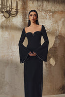 L'SCARLETT long-sleeve gown in soft fabric with a flowing design, featuring a V-neck and elegant silhouette.