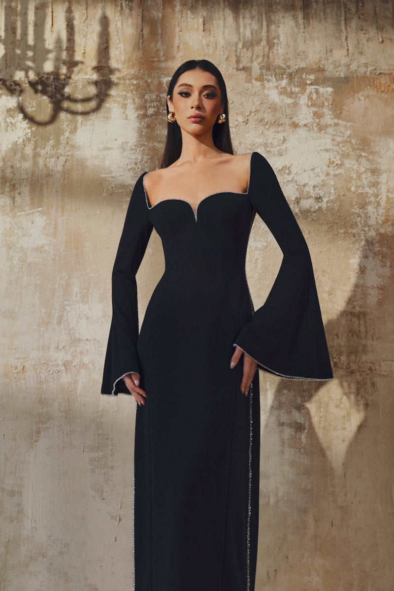 Long-sleeve L'SCARLETT gown featuring a soft fabric, elegant design, and flowing silhouette for comfortable evening wear.