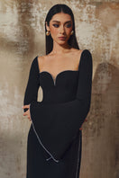 L'SCARLETT long-sleeve gown in soft fabric, featuring a flowing design and elegant neckline, perfect for formal occasions.