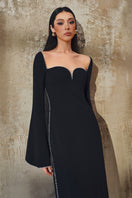 L'SCARLETT long-sleeve gown in soft fabric with a flowing design, featuring a fitted waist and elegant neckline.