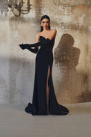 L'SCARLETT off-shoulder long-sleeve mermaid gown in elegant fabric, fitted silhouette with flared hem and intricate detailing.