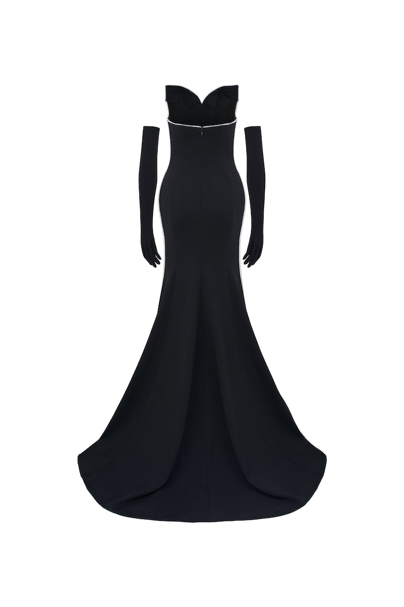 Black off-shoulder long-sleeve mermaid gown by L'SCARLETT displayed on a mannequin, showcasing elegant fitting and fabric details.