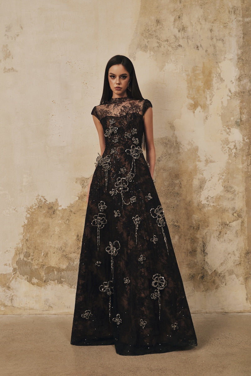 Black A-line maxi dress with high neck, short sleeves, and 3D crystal floral details by L'SCARLETT.