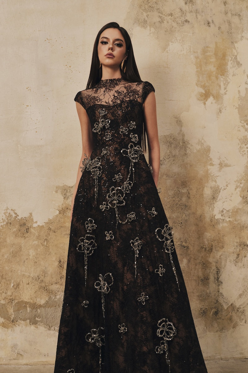 Black A-line maxi dress with high neck, short sleeves, and 3D crystal floral details by L'SCARLETT, perfect for elegant occasions.