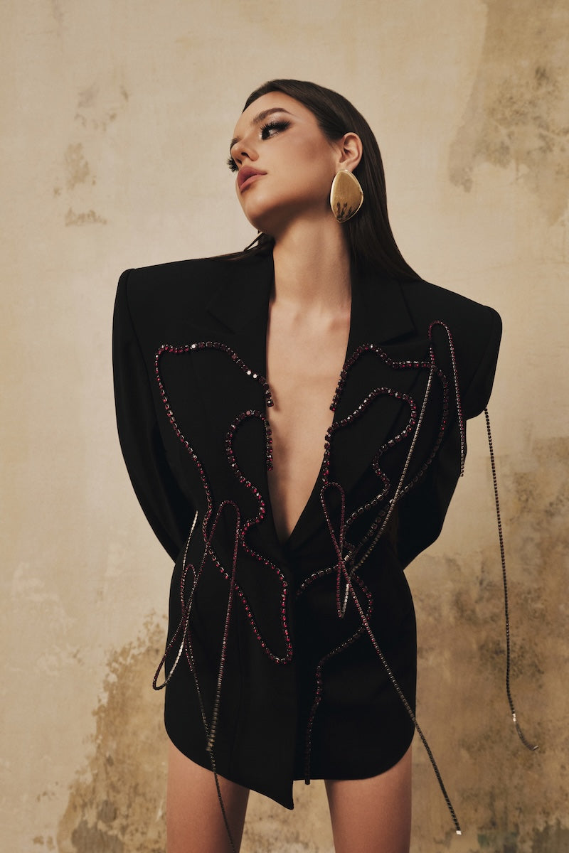 Black long-sleeve beaded mini blazer dress by L'SCARLETT, featuring a fitted silhouette and decorative heart beading details.