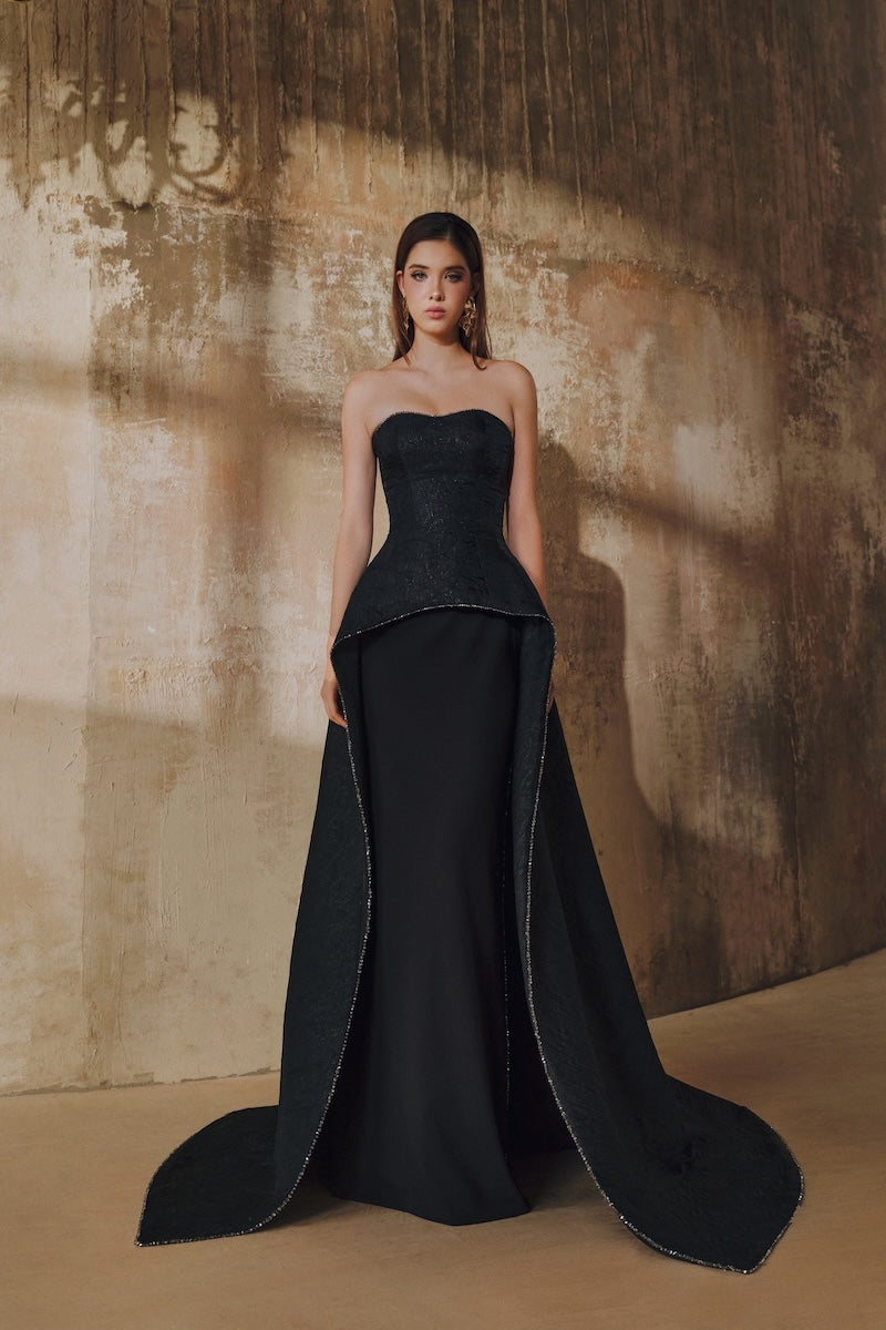 Black strapless floor-sweeping mullet overskirt maxi dress by L'SCARLETT, featuring a flowing silhouette and elegant design.