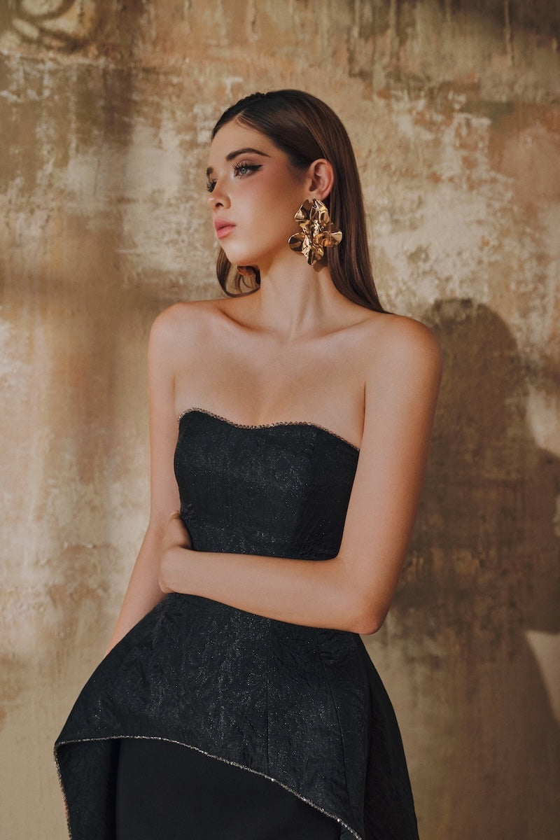 Black strapless floor-sweeping maxi dress by L'SCARLETT featuring a stylish mullet overskirt and elegant design.