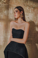 Elegant strapless floor-sweeping mullet overskirt gown by L'SCARLETT, featuring flowing fabric and a stylish high-low hem design.