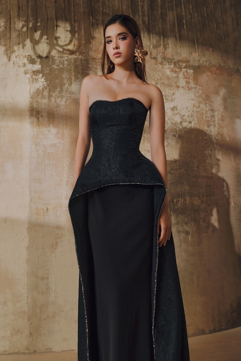 Black strapless floor-sweeping mullet overskirt maxi dress by L'SCARLETT, featuring a flowing, elegant design and fitted bodice.