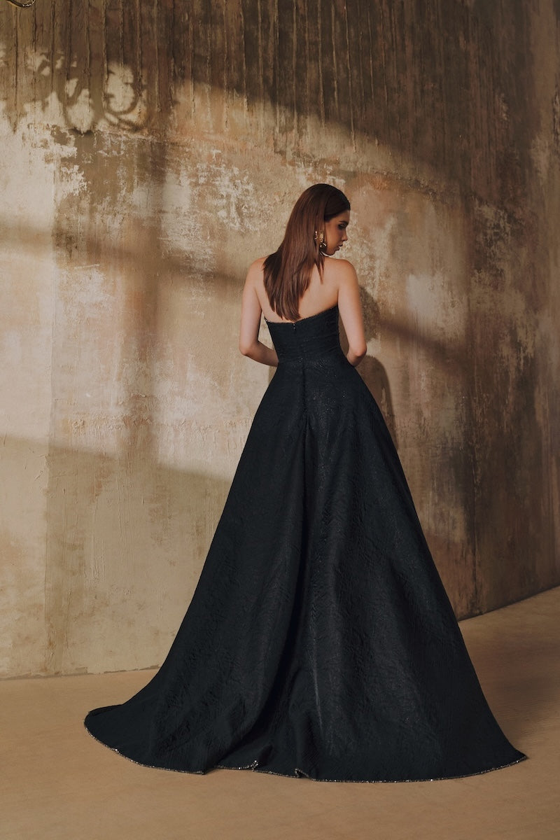 Black strapless floor-sweeping maxi dress by L'SCARLETT, featuring a mullet overskirt design, elegant and flowing.