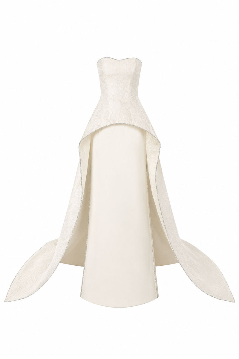 L'SCARLETT strapless off-white floor-sweeping maxi dress with a mullet overskirt, front view showcasing elegant flowing fabric.