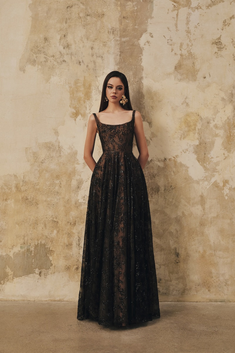 Black L'SCARLETT flared maxi dress with wide shoulder straps and crystal beading, elegant evening wear.