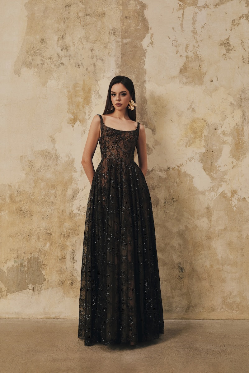 Black L'SCARLETT flared maxi dress with wide shoulder straps and crystal beading, elegant evening wear.