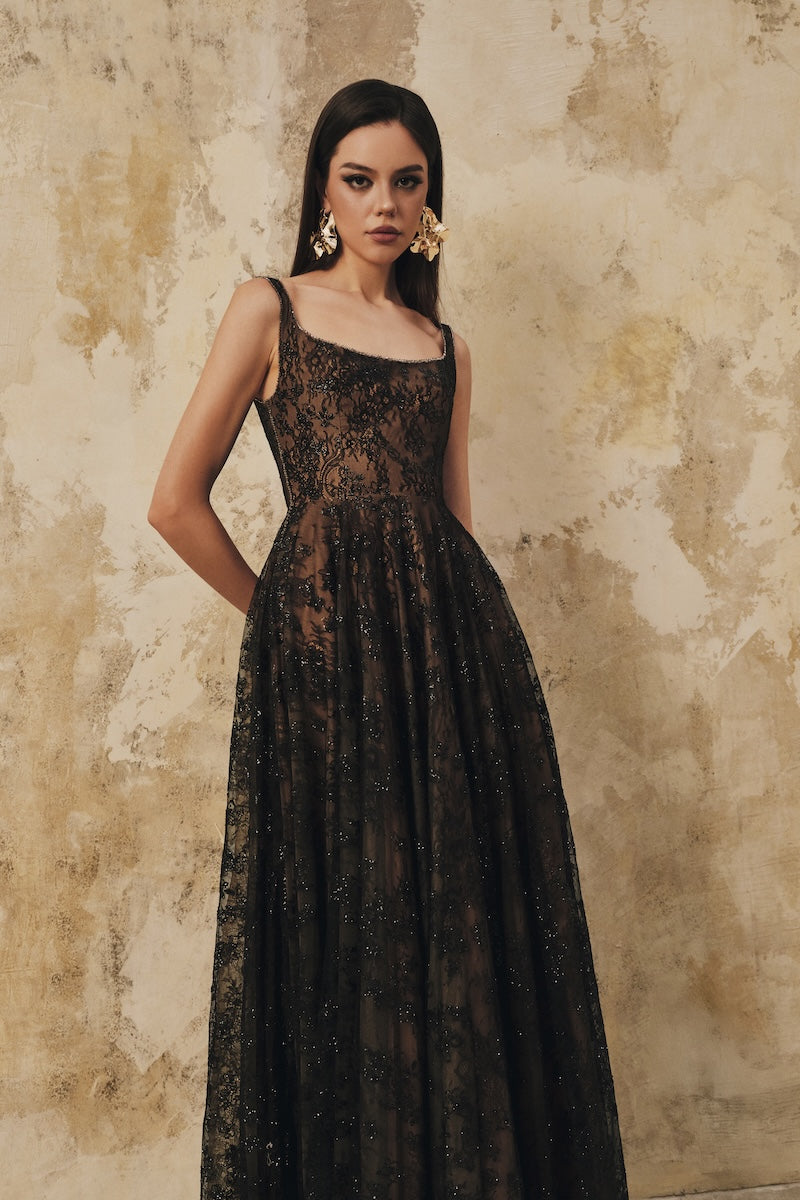 Black L'SCARLETT flared maxi dress with wide shoulder straps and crystal beading, elegant and flowing for formal occasions.