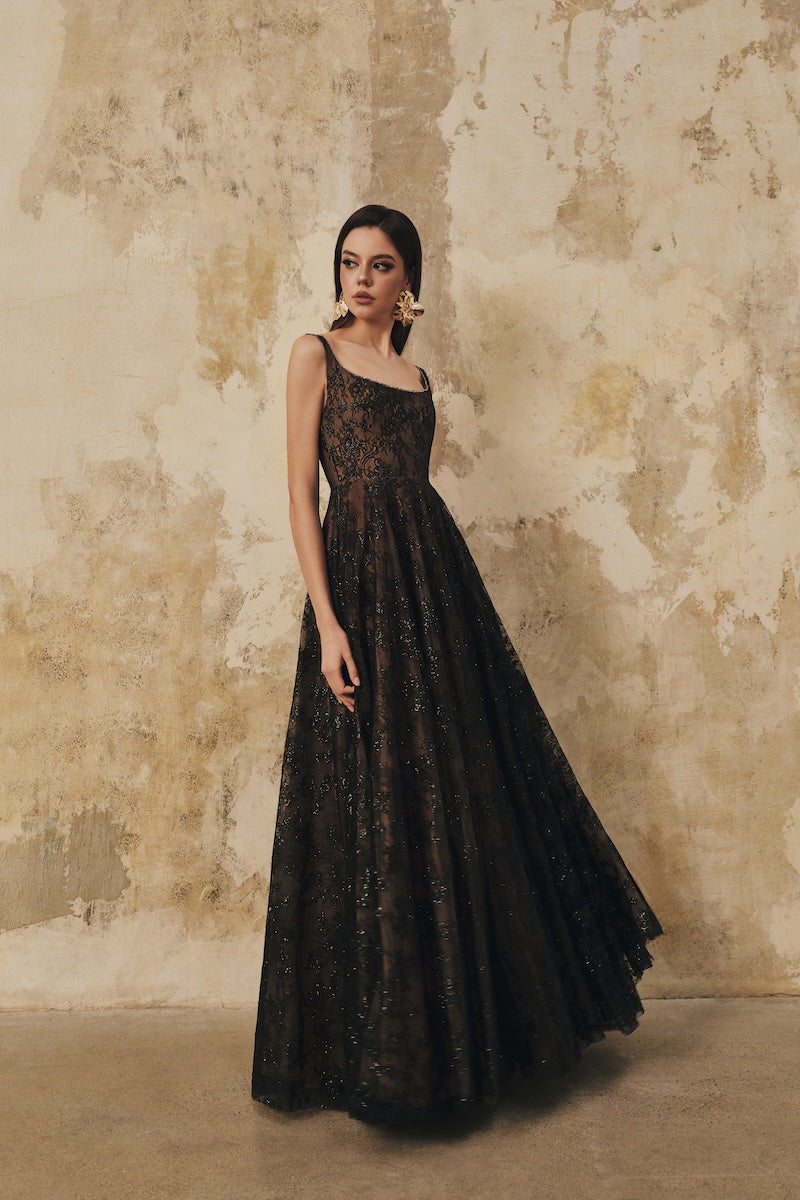 Black L'Scarlett flared maxi dress with wide shoulder straps and crystal beading, elegant evening gown with flowing silhouette.