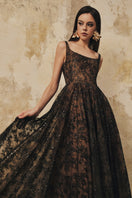 L'SCARLETT flared gown with wide shoulder straps and intricate crystal beading, elegant evening dress displayed on a mannequin.