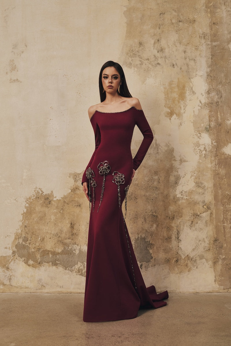 L'SCARLETT burgundy fitted maxi dress with softly curved neckline and 3D crystal floral details, full-length view.