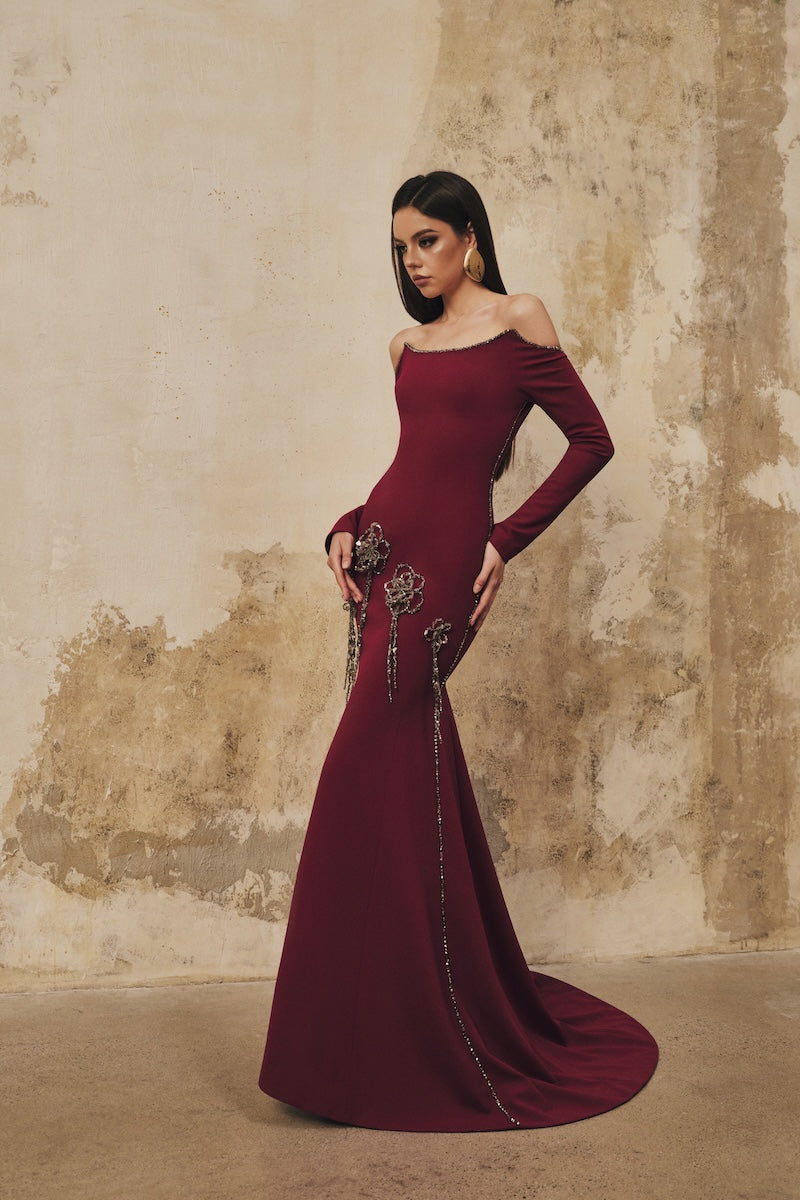 L'SCARLETT burgundy maxi dress with fitted softly curved neckline and 3D crystal floral embellishments, full-length gown on model