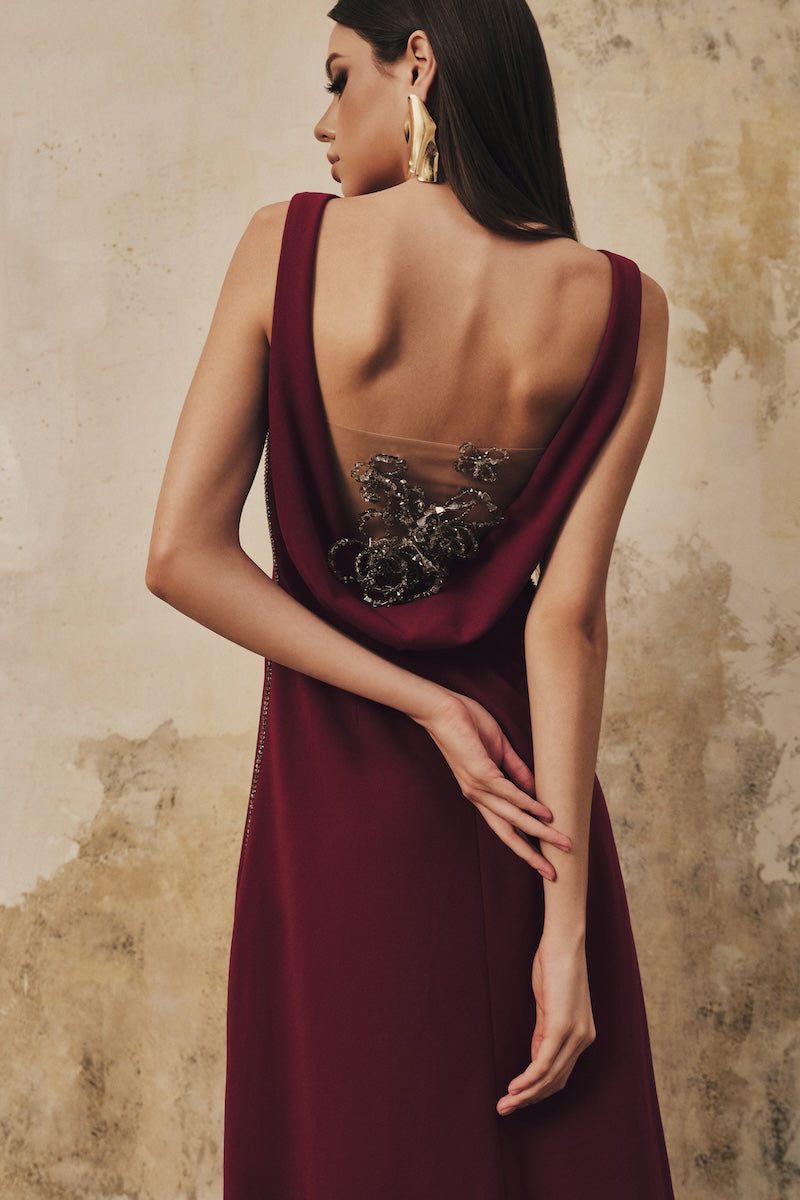 L'SCARLETT burgundy draped-back sleeveless maxi dress with 3D crystal floral details, elegant design perfect for formal occasions.