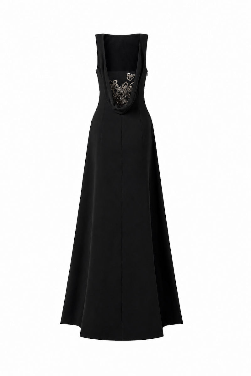 Black draped-back sleeveless maxi dress with 3D crystal floral details by L'SCARLETT, showcasing elegant flowing fabric and intricate embellishments.