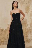 Black A-line spaghetti-strap gown with crystal beading by L'SCARLETT, featuring elegant design and intricate details.