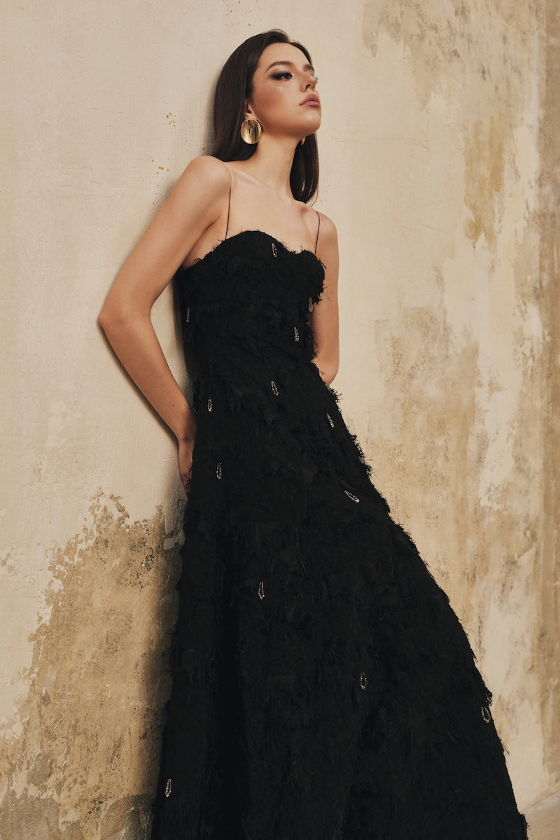 Black A-line spaghetti-strap midi dress with crystal beading from L'SCARLETT, featuring elegant design and sleek silhouette.