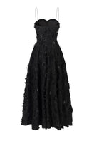 Black A-line spaghetti-strap gown with crystal beading by L'SCARLETT, shown from the back with flowing fabric and elegant design.
