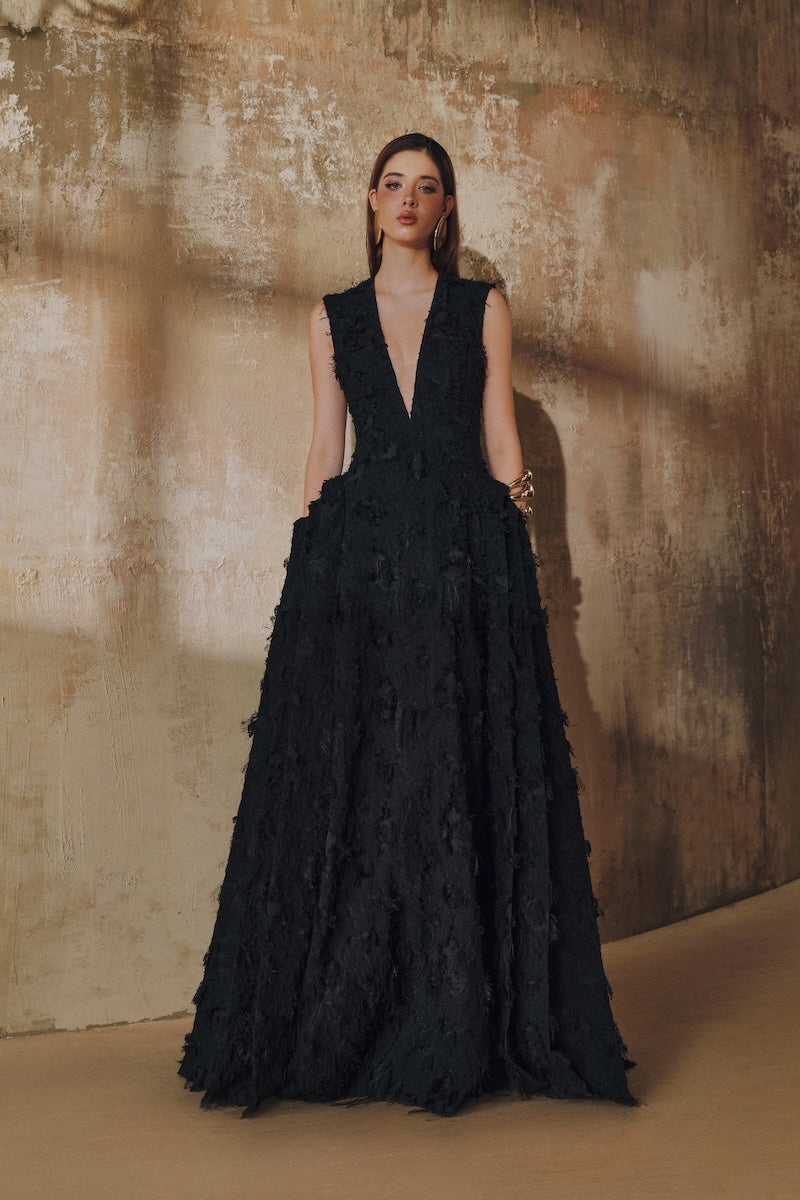 Black sleeveless V-neck maxi dress by L'SCARLETT featuring fringe, jacquard pattern, and layered side panels.
